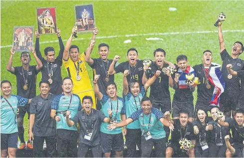  ??  ?? Thai players and officials celebrate winning the men’s football gold medal at the 29th SEA Games in Malaysia on Tuesday night.