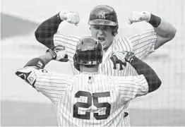  ?? GREGORY BULL AP ?? Yankees’ Luke Voit celebrates with Gleyber Torres (25) after Voit hit a solo home run against Tampa Bay in the second inning of Game 4 of the ALDS.