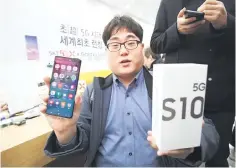  ??  ?? The day’s first SKTelecom 5G customer shows his new Samsung Galaxy S10 5G smartphone during a launch event at an SKTelecom shop in Seoul on April 5. Samsung was also launching its top-end Galaxy S10 5G smartphone, after South Korea this week won the global race to commercial­ly launch the world’s first nationwide 5G networks. — AFP photo