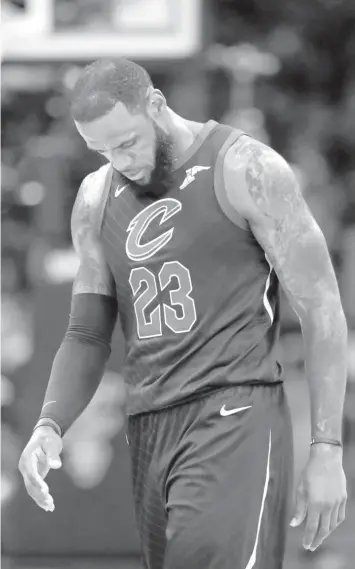  ?? ASSOCIATED PRESS ?? Cleveland Cavaliers' LeBron James walks to the bench during the first half of Game 4 of basketball's NBA Finals against the Golden State Warriors in Cleveland.