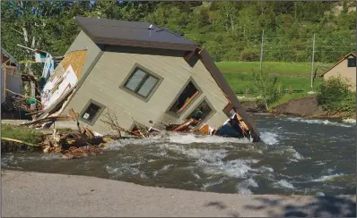  ?? (File Photo/ap/david Goldman) ?? A house sits in Rock Creek on June 15 after floodwater­s washed away a road and a bridge in Red Lodge, Mont.