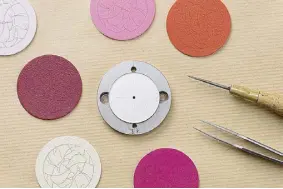  ??  ?? On an inch-perfect dial, the Hermès leather artisans compose a variegated work with slim leather fragments carefully selected, cut out and juxtaposed to create a pattern. Each dial artwork takes six hours to assemble alone.