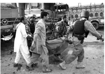  ??  ?? Afghans carry a victim of bomb attack in Jalalabad, Nangarhar province, east of Kabul, Afghanista­n. ASSOCIATED PRESS