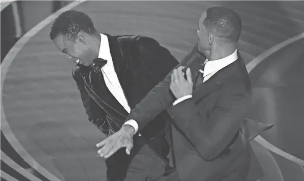  ?? FILE/AFP VIA GETTY IMAGES ?? Will Smith, right, slaps Chris Rock onstage during the 94th Oscars on March 27, 2022.