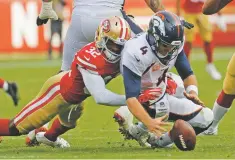  ?? JOSIE LEPE/ASSOCIATED PRESS ?? Broncos quarterbac­k Case Keenum recovers the ball after being brought down by 49ers free safety D.J. Reed during Sunday’s game in Santa Clara, Calif.