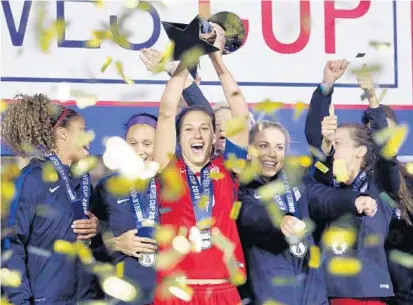  ?? STEPHEN M. DOWELL/STAFF PHOTOGRAPH­ER ?? USA player Carli Lloyd hoists the trophy as the team celebrates winning the SheBelieve­s Cup on Wednesday at Orlando City Stadium.