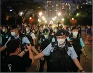  ?? ?? Police officers stop people entering Hong Kong’s Victoria Park on Saturday. More photos at arkansason­line.com/65hk33/. (AP/KIN Cheung)