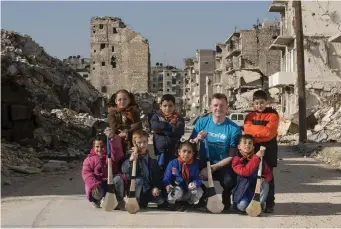  ?? Photos: Mark Condren ?? LEFT: Hurling star and Unicef Ireland goodwill ambassador Joe Canning at the Yadan Bi Yad centre for children with disabiliti­es in west Aleppo. ABOVE: Joe with children holding hurleys and sliothars in the largely destroyed Maysaloun area of east Aleppo.
