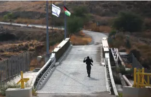  ?? (Ronen Zvulun/Reuters) ?? AN ISRAELI soldier patrols the border area between Israel and Jordan at Naharayim.