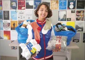  ??  ?? Southwest High student Hailey Contreras, 14, poses with bags of socks she donated for the school's annual Socktober charity drive event on Friday afternoon at Southwest High School in El Centro. VINCENT OSUNA PHOTO