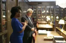  ?? Lisa HeNdiN / PHoto courtesy of NatioNaL GeoGraPHic ?? SEEKING TRUTH: DeNeen Brown and Marc Carlson look through archives of the 1921 Tulsa Race Massacre, stored in the McFarlin Library at the University of Tulsa.