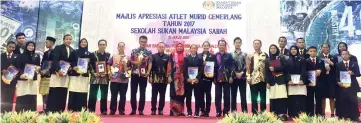  ??  ?? Maimunah and Madsarin (both standing centre) together with the award recipients.