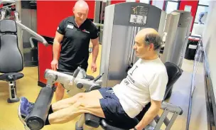  ??  ?? ●●Brian Povey with his trainer in the gym
