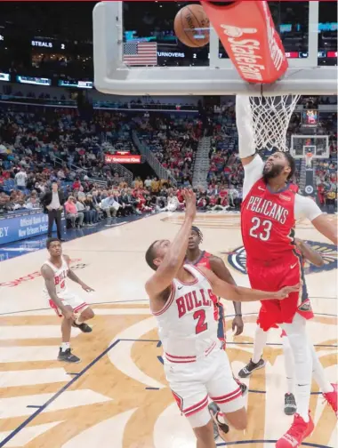  ?? GERALD HERBERT/AP ?? Pelicans big man Anthony Davis goes up to block a shot by Bulls forward Jabari Parker in the first half Wednesday night. Davis had 32 points, 15 rebounds, seven assists and four blocks.