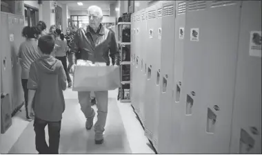  ?? VINCENZO D’ALTO/ THE GAZETTE ?? Fred Griffith, nicknamed “the food man” by students, makes a delivery to école La Mennais Tuesday on behalf of Generation­s Foundation. This year, the non-profit organizati­on will deliver food, snacks and milk to 6,500 children in 72 schools.