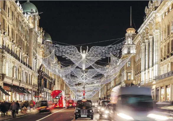  ?? GETTY IMAGES ?? Christmas angel lights float over the streets of Mayfair, London, England. The best way to enjoy the festive sights at this time of year is to bundle up and head out on foot.