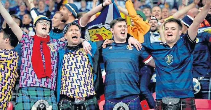  ??  ?? SUMMER OF SPORT: Scotland supporters at the Euro 2020 match against England at Wembley Stadium. It would be unfair not to allow sport at a local level to welcome back fans.