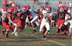  ?? LARRY GREESON / For the Calhoun Times ?? Sonoravill­e’s Noah Sullivan (14) looks for running room between several defensive players from the Gray team in the fourth quarter on Friday.