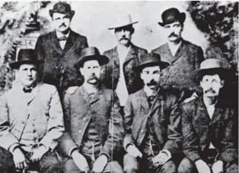  ?? THE ASSOCIATED PRESS ?? U.S. lawmen including Bat Masterson (back row, right) and Wyatt Earp (front row, second from left), are seen in 1883. Contrary to the Hollywood version, most towns in the Old West prohibited the carrying of firearms.