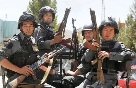  ?? Reuters ?? Afghan policemen arrive at the site of a suicide attack in the embassy area in Kabul last month