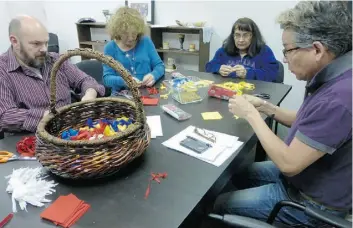  ?? Supplied ?? Volunteers at McDougall United Church make tobacco prayer ties for a worship service.