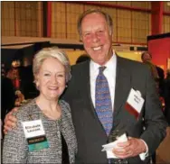  ??  ?? Chester County Historical Society President Elizabeth Laurent gets a pat on the shoulder for the evening’s success from John Hunt.