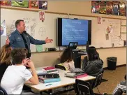  ??  ?? Officer Brad Eshler talks with students at Tower Heights Middle School about internet safety and social media.