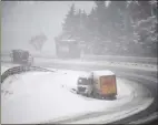  ??  ?? Snow on the M74 caused chaos with cars and lorries struggling to cope with the difficult driving conditioin­s.
