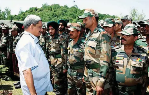  ??  ?? The then Defence Minister Manohar Parrikar interactin­g with the troops in Rajouri sector, Jammu and Kashmir, in May 2015