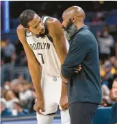  ?? DOUG MCSCHOOLER/AP ?? Brooklyn Nets forward Kevin Durant talks with coach Jacque Vaughn during a Nov. 25 game against the Indiana Pacers in Indianapol­is.