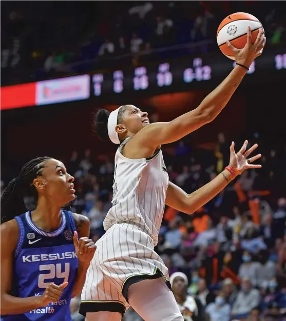  ?? SEAN D. ELLIOT/AP ?? Parker, who’s now 12th on the WNBA’s all-time scoring list, beats Sun forward DeWanna Bonner to the basket during a Sky playoff game in September.