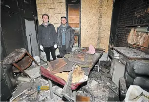  ?? PHOTOS BY BARRY GRAY THE HAMILTON SPECTATOR ?? Grey Harbour Tattoo owners Thomas Penny and Rob Veinotte stand in the burned out ruins of their James Street North shop, which was destroyed by arson last week.