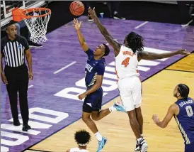  ?? AJ MAST / AP ?? The nation’s leading scorer, Oral Roberts’ Max Abmas (left) drives past Florida’s Anthony Duruji during their 81-78 upset win Sunday. Abmas is averaging 27.5 ppg in the tournament as they ready for Sweet 16 foe and neighbor Arkansas.