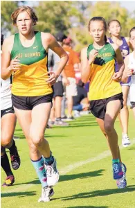  ??  ?? Los Alamos runners Norissa Valdez (left) and Lidia Appell are two cornerston­es of the Hilltopper­s squad, which hopes to return to the state championsh­ip.