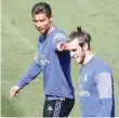  ?? — Reuters ?? Real Madrid’s Cristiano Ronaldo points out team-mate Gareth Bale during a training session.