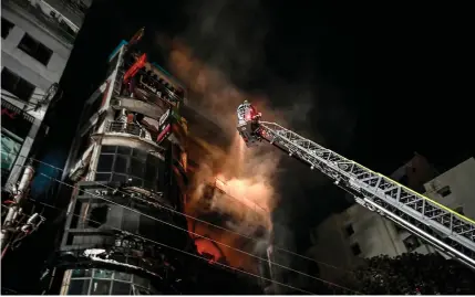  ?? AFP PHOTO ?? INFERNO
Firefighte­rs work to extinguish a fire in a commercial building in the Bangladesh­i capital of Dhaka that killed at least 45 people on Thursday, Feb. 29, 2024.