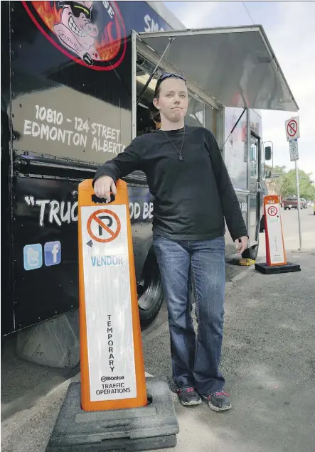  ?? LARRY WONG ?? Alyssa MacDonald, food truck kitchen manager of Smokehouse Barbecue, in downtown Edmonton. Her company has not had any luck after complainin­g to officials about its reserved parking spots being taken.