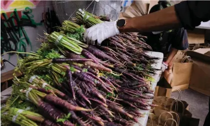  ?? Photograph: Spencer Platt/Getty Images ?? Members of Universe City pack bags of fresh produce from Green Top Farms in Brooklyn, New York City.