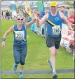  ??  ?? Sister and brother Margaret Sinclair and Robert Semple cross the finish line together after completing the half marathon in 2017.