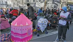  ?? LUIS ROBAYO / AFP ?? Members of social organisati­ons grouped together under the Unidad Piquetera banner camp out during a protest at Plaza de Mayo square in front of Casa Rosada.