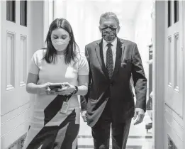  ?? J. SCOTT APPLEWHITE/AP ?? Sen. Joe Manchin, D-W.Va., makes his way through the U.S. Capitol after attending a meeting Thursday as the Senate grapples with year-end tasks in Washington.