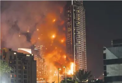  ??  ?? Flames tear through the 63- story Address Downtown hotel, near the world’s tallest tower, in Dubai on Thursday night. People were gathering to watch New Year’s celebratio­ns when the hotel caught fire. Karim Sahib, AFP/ Getty Images