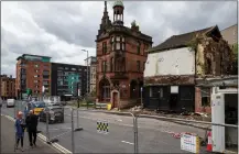  ??  ?? Demolition work being carried out yesterday on buildings in a block on the corner of High Street and George Street, Glasgow, following a recent fire