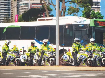  ??  ?? A group of motorbike police officers patrolling the streets of the Gold Coast yesterday as Games fever builds.