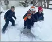  ??  ?? Jacob Derer, 10; Mark Derer, 7; Tyler McGee, 9; Austin Gassert, 6, all of Birdsboro, work on building their snowman for the Hawk Mountain Council Snowman Challenge.