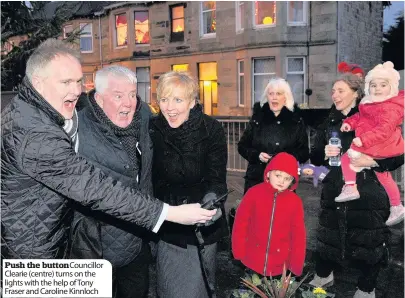  ??  ?? Push the button Councillor Clearie (centre) turns on the lights with the help of Tony Fraser and Caroline Kinnloch