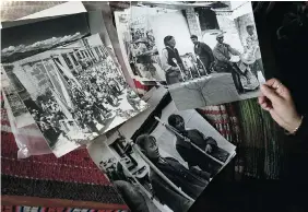  ?? ANDY WONG/The Associated Press ?? Tsering Woeser, a Tibetan poet, displays photos taken by her father during China’s Cultural Revolution showing the Chinese military destroying temples and persecutin­g Buddhist
priests and officials in the far western region of Tibet.