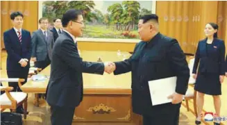  ?? REUTERSPIX ?? ... North Korean leader Kim Jong-un shakes hands with Chung Eui-yong, who is leading a visiting South Korean delegation, in this photo released by Korean Central News Agency yesterday. Chung later said the two Koreas have agreed to hold a summit at the...