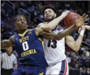  ?? TONY AVELAR - THE ASSOCIATED PRESS ?? Gonzaga guard Josh Perkins (13) grabs a rebound next to West Virginia guard Teyvon Myers during the second half of an NCAA Tournament college basketball regional semifinal game Thursday, in San Jose, Calif.