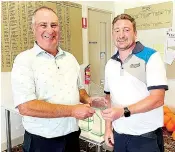  ?? ?? Phil Adams (left) doubled up at the Drouin Golf Club championsh­ips winning the B grade and senior titles. He receives congratula­tions from captain Glenn Robinson.